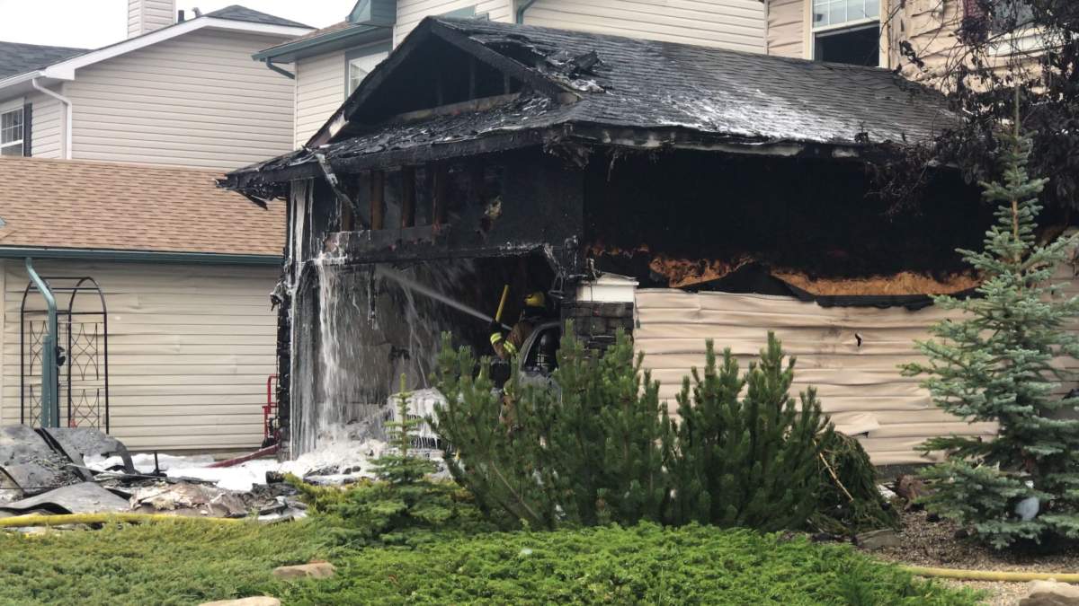 Fire crews hosing down what remains of a garage after a fire in Bridlewood.