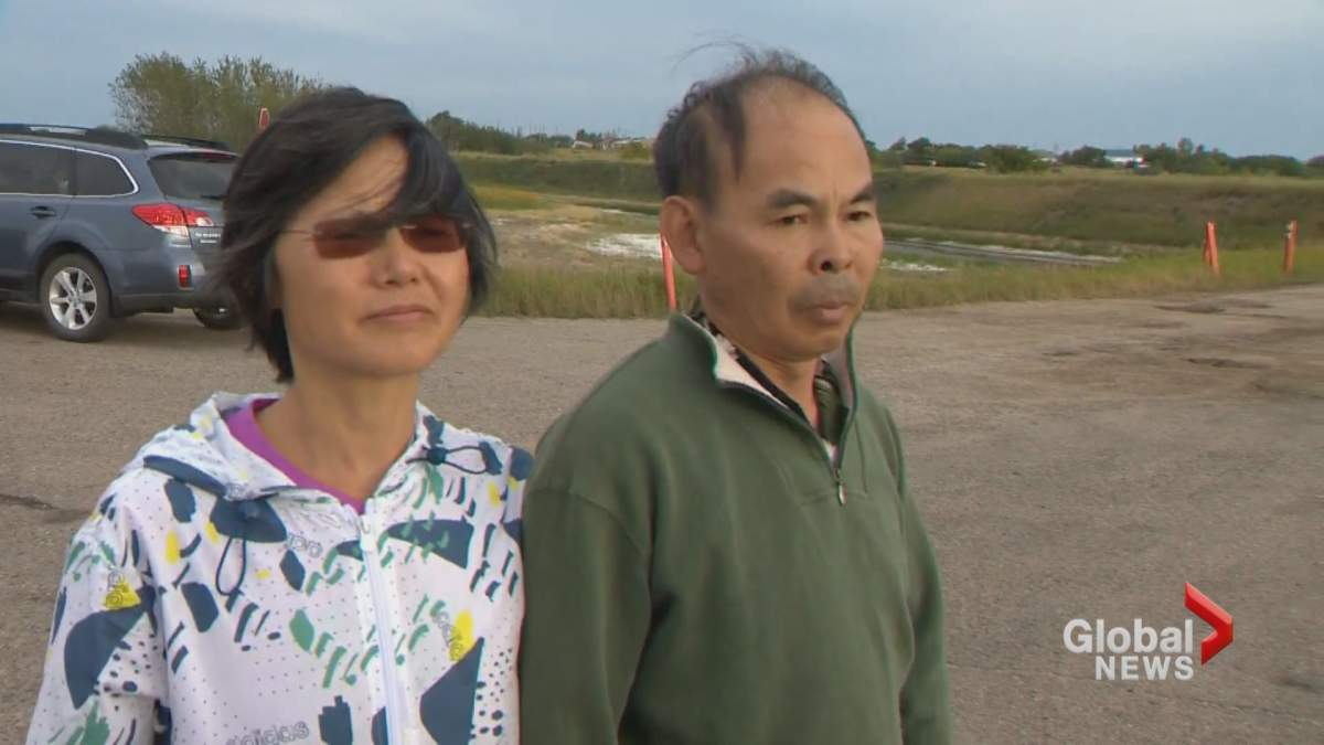 Qiaoqin Yang and Nanfang Zhao, friends of a Saskatoon couple killed in a crash near Cereal, Alta., visited the crash site on Thursday, Aug. 22.