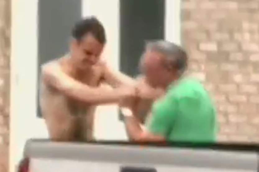 Matthew Thomas Bernard, left, is shown grappling with Lloyd Gaudlin outside the Keeling Baptist Church in Keeling, Va., in this still image from video on Aug. 27, 2019.
