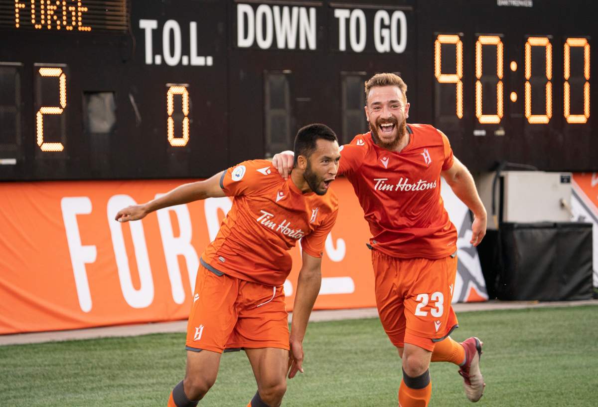 Hamilton Forge FC's David Choiniere (7) celebrates his game-winning goal with teammate Anthony Novak (23) during second-half Scotiabank CONCACAF League soccer action against Antigua Guatemala FC, in Hamilton, Ont., Thursday, Aug. 1, 2019. 
