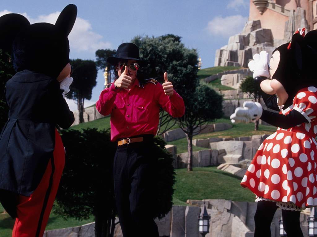 Michael Jackson gives a thumbs up to Mickey and Minnie Mouse at Disneyland Paris, in France.