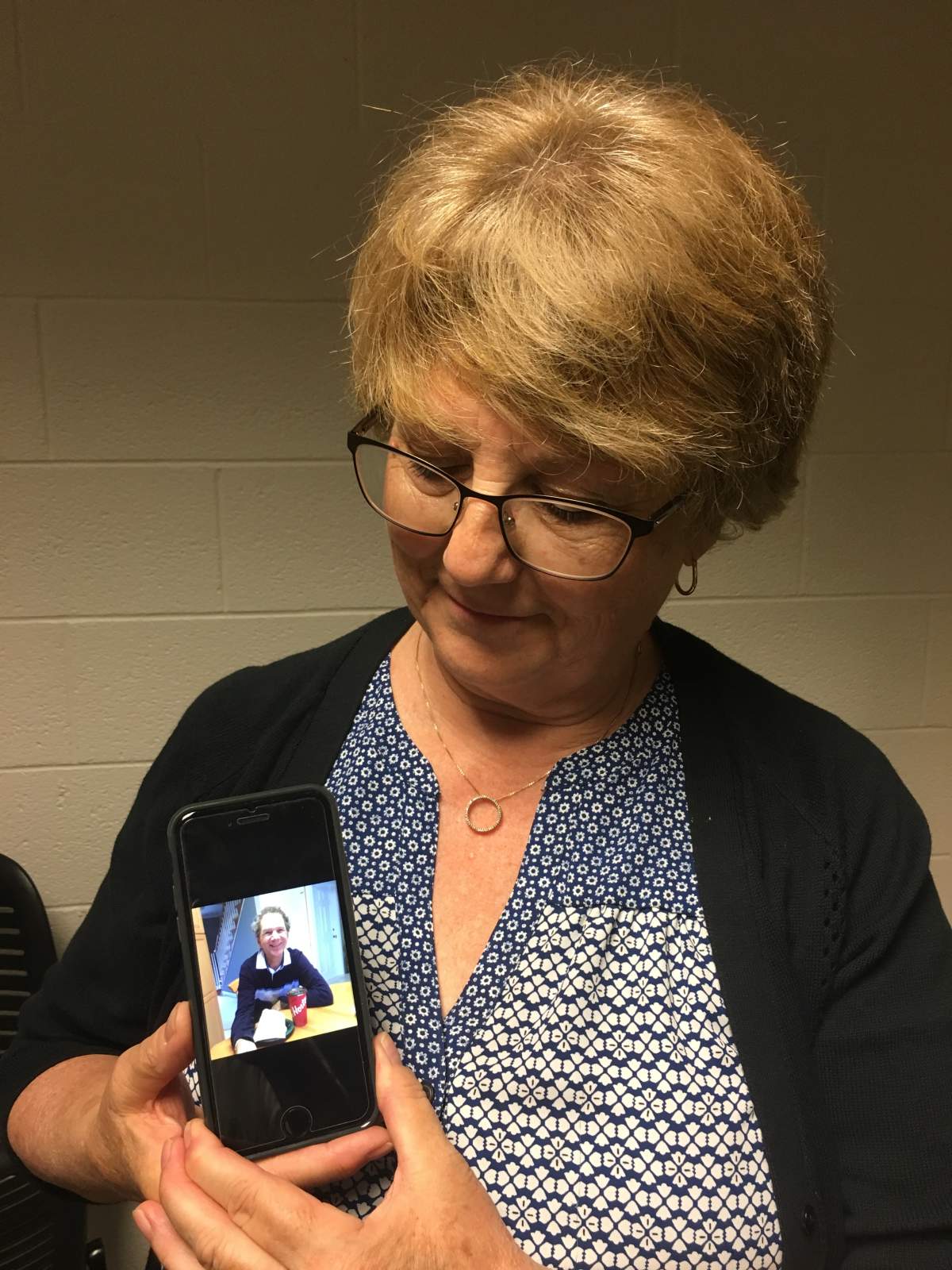 Deb Weber holding a photo of her husband Bruce, who has dementia. Bruce has been a client of MedicAlert for the past few years.