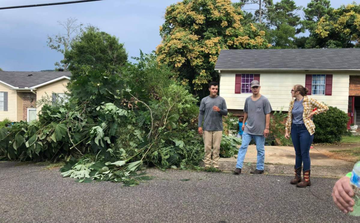Volunteers gathered to help clean up Randa Ragland’s yard.