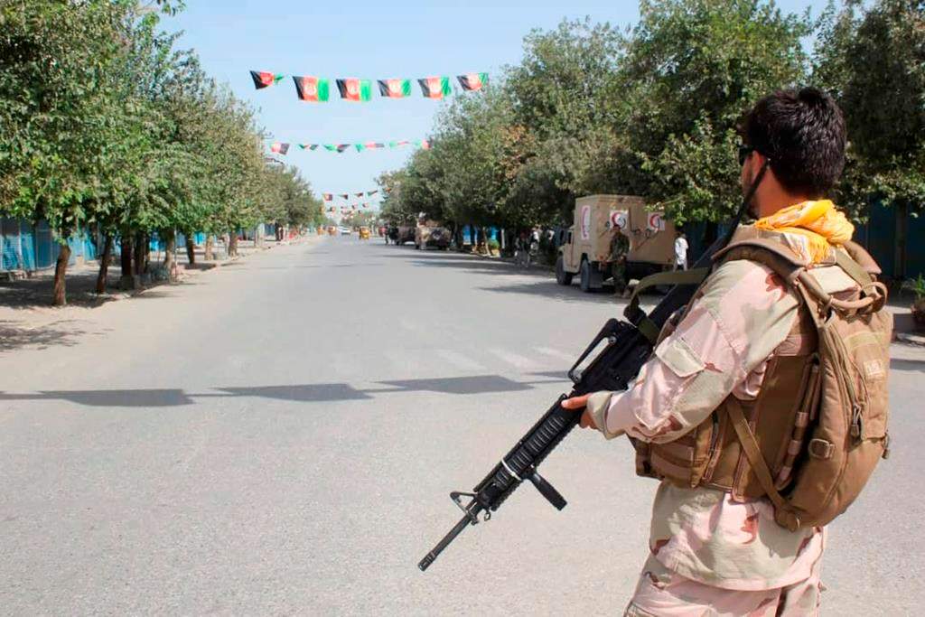 Afghan security forces stand guard during a fight against Taliban fighters in Kunduz province north of Kabul, Afghanistan, Saturday, Aug. 31, 2019.