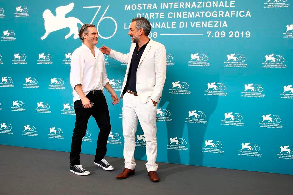 Actor Joaquin Phoenix, left, greets director Todd Phillips at the photocall for the film ‘Joker’ at the 76th edition of the Venice Film Festival in Venice, Italy, Saturday, Aug. 31, 2019. (Photo by Joel C Ryan/Invision/AP)