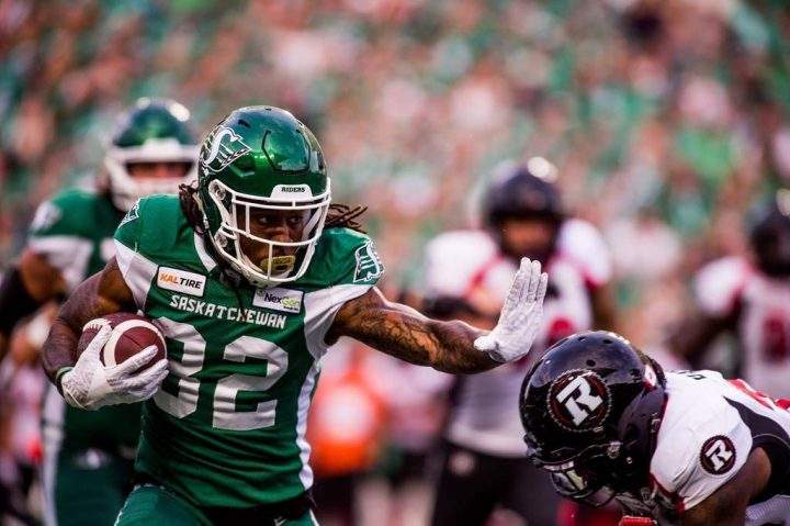 Saskatchewan Roughriders wide receiver Naaman Roosevelt (82) runs the ball under pressure during second half CFL action against the Ottawa Redblacks, in Regina, Saturday, Aug. 24, 2019.