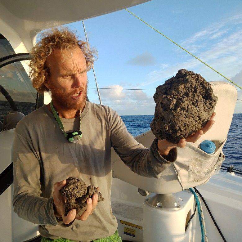 Sailor Michael Hoult is shown with two pumice rocks he recovered from the ocean on Aug. 15, 2019.