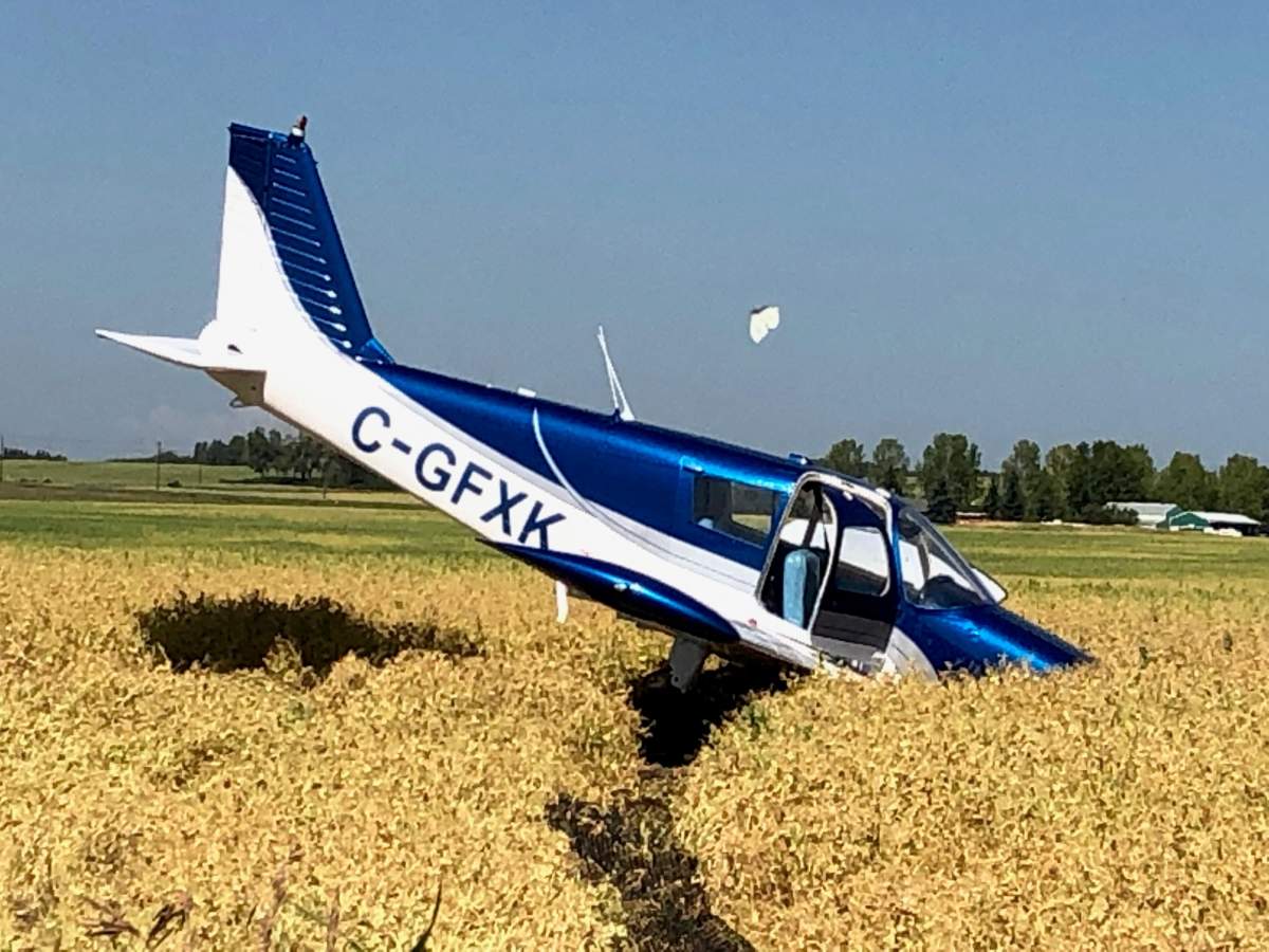 A small airplane is seen nose-down in an Okotoks field following a crash landing on Thursday, Aug. 8, 2019.