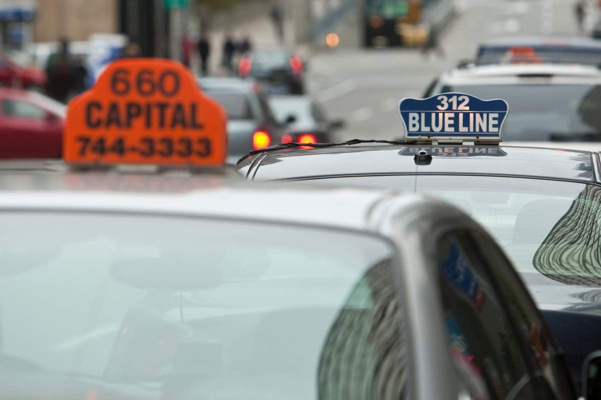 A Blue Line taxi and a Capital taxi sit parked in Ottawa Monday September 27, 2010.