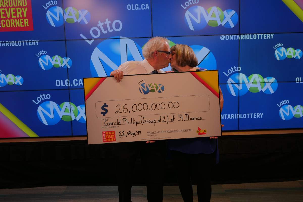 The $26-million winners share a smooch, celebrating their mega Lotto Max win.