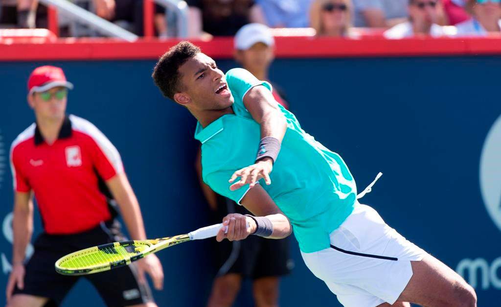 Felix Auger-Aliassime of Canada loses his balance as he returns to Karen Khachanov of Russia during round of sixteen play at the Rogers Cup tennis tournament Thursday August 8, 2019 in Montreal.