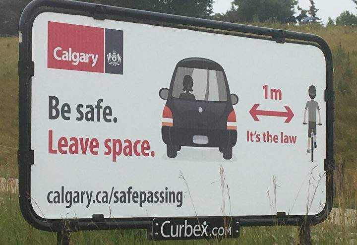 A City of Calgary sign warning drivers to leave space for cyclists.