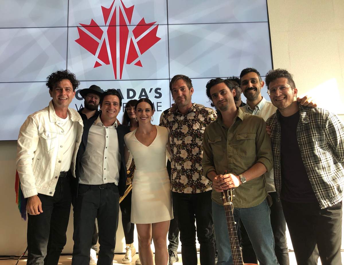 Scott Moir, second from left, and Tessa Virtue, third from left, are joined by Hamilton rock band Arkells during a celebration of the figure skating pair's spot on Canada's Walk of Fame in London, Ont.