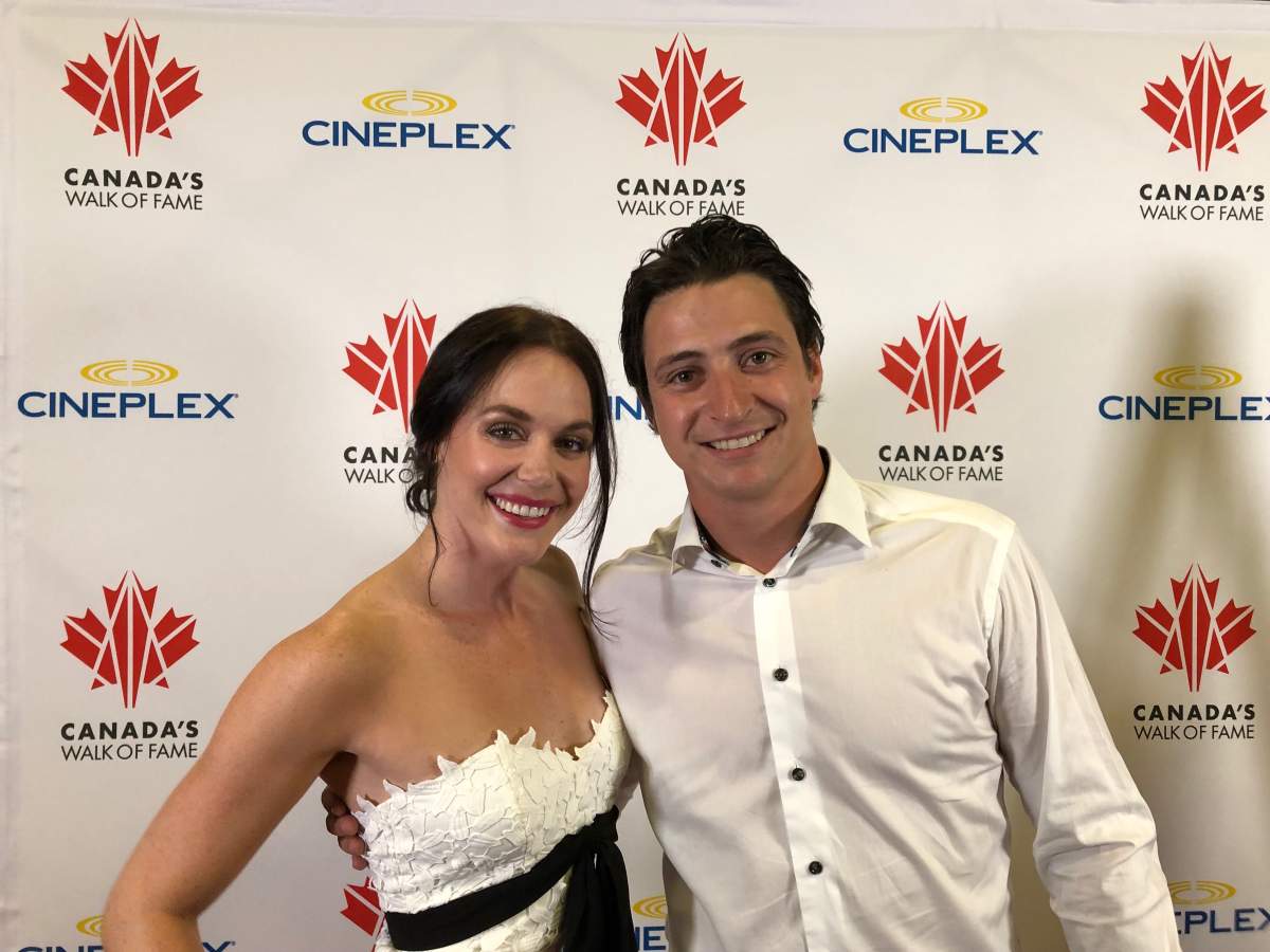 Tessa Virtue and Scott Moir smile together inside Ilderton Arena in Ilderton, Ont.