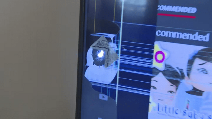 A bullet hole is seen in Walli Mohammad’s TV after a stray bullet went through his apartment window early Saturday.