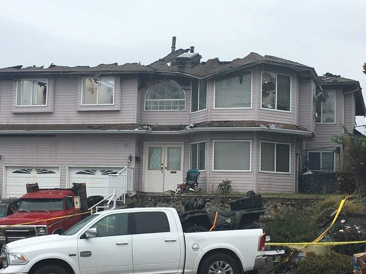 A closer view of the fire-damaged home.