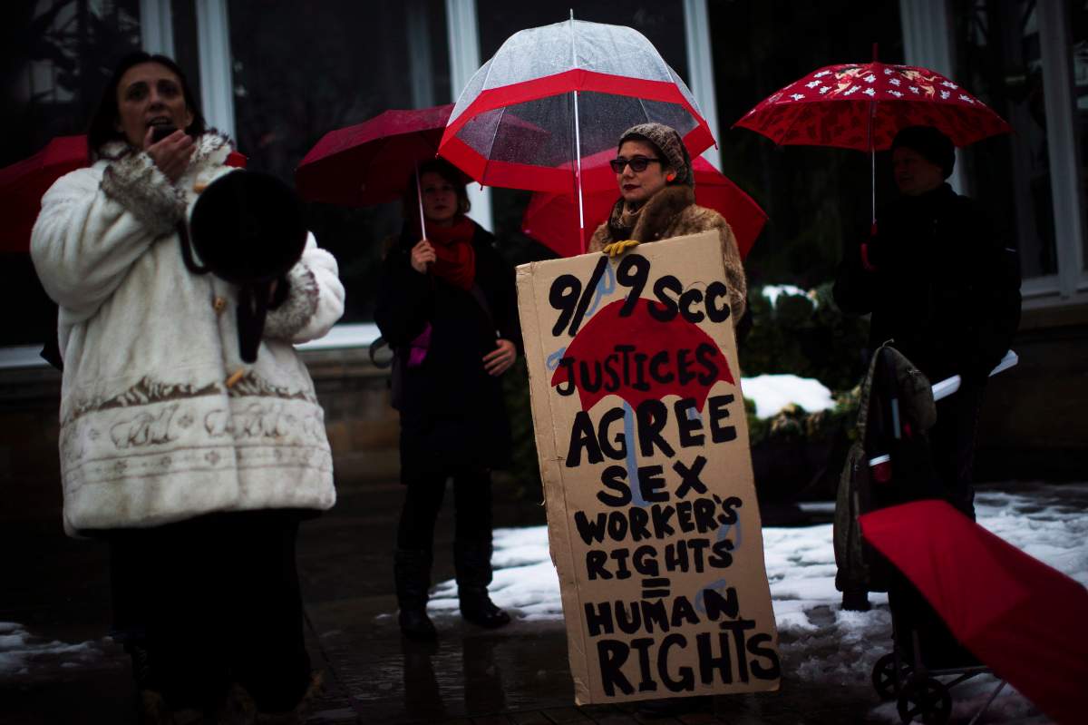 Protestors are seen during rally at Allan Gardens in Toronto. 