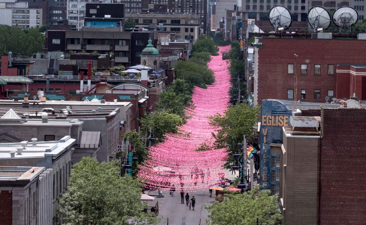 The strings of plastic balls above Ste-Catherine Street were initially pink. In 2017, the art installation became a rainbow.