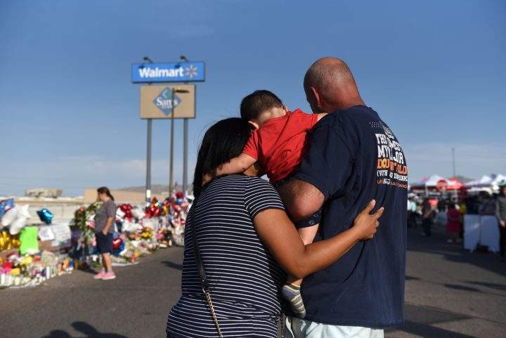 Norma, Luke and Mark Jimerson pay their respects at a memorial four days after a mass shooting at a Walmart store in El Paso, Texas, U.S. Aug. 7, 2019.  