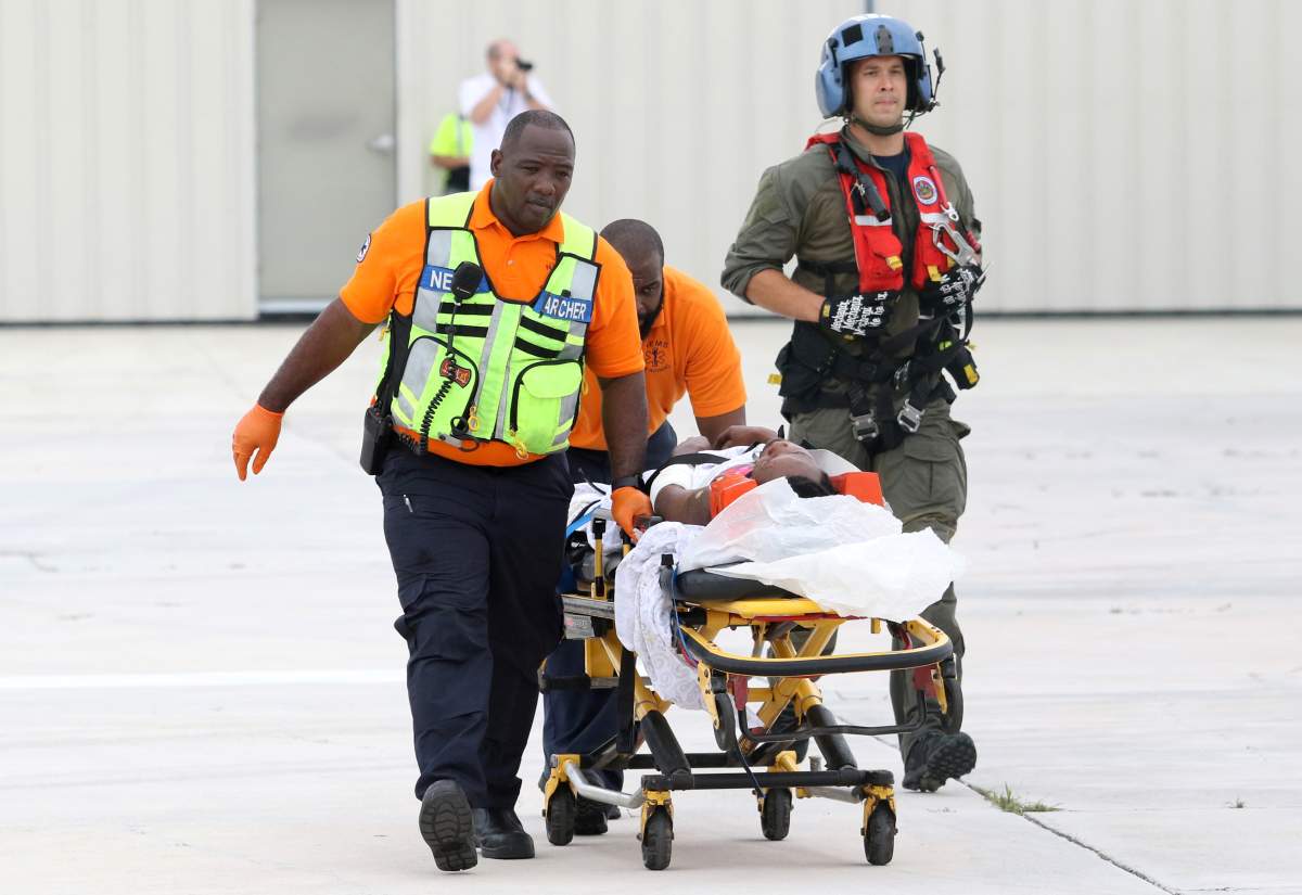U.S. Coast Guard personnel wheel an evacuee on a stretcher, rescued from Abaco Island after hurricane Dorian, in Nassau, Bahamas, September 3, 2019. (REUTERS/John Marc Nutt)
