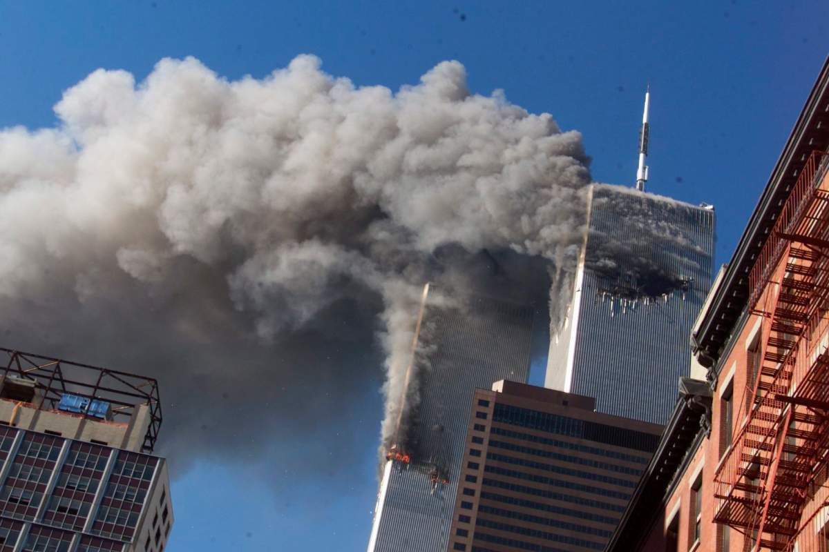Smoke rises from the burning twin towers of the World Trade Center after hijacked planes crashed into the towers in New York City on Sept. 11, 2001.