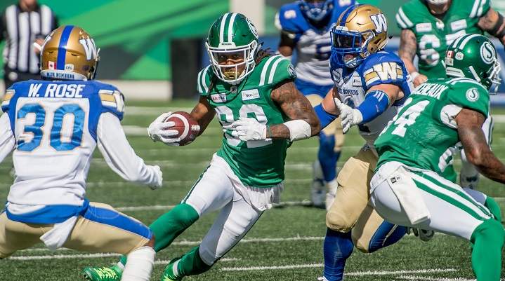 Saskatchewan Roughriders wide receiver Naaman Roosevelt (82) runs the ball under pressure from the Winnipeg Blue Bombers defence during second half CFL action in Regina in the Labour Day Classic. The Saskatchewan Roughriders defeated the Winnipeg Blue Bombers 19-17 on Sept 1, 2019.