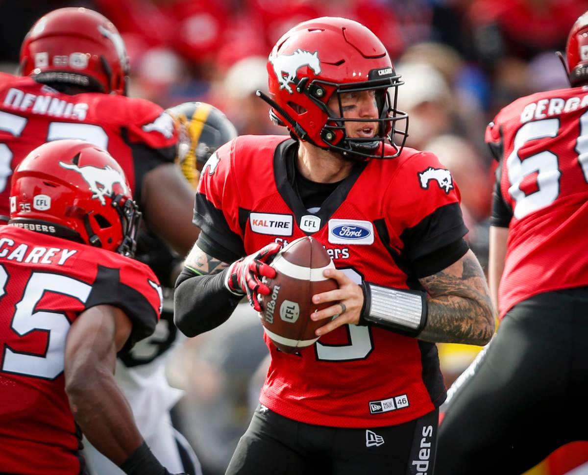 Calgary Stampeders quarterback Bo Levi Mitchell looks for a receiver during second half CFL football action against the Hamilton Tiger-Cats in Calgary, Saturday, Sept. 14, 2019.