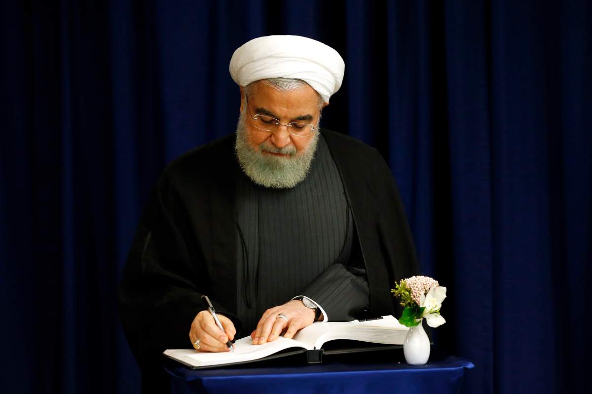 Iran's President Hassan Rouhani signs the guest book during a meeting with United Nations Secretary-General Antonio Guterres during the 74th session of the U.N. General Assembly, at U.N. headquarters, Wednesday, Sept. 25, 2019.