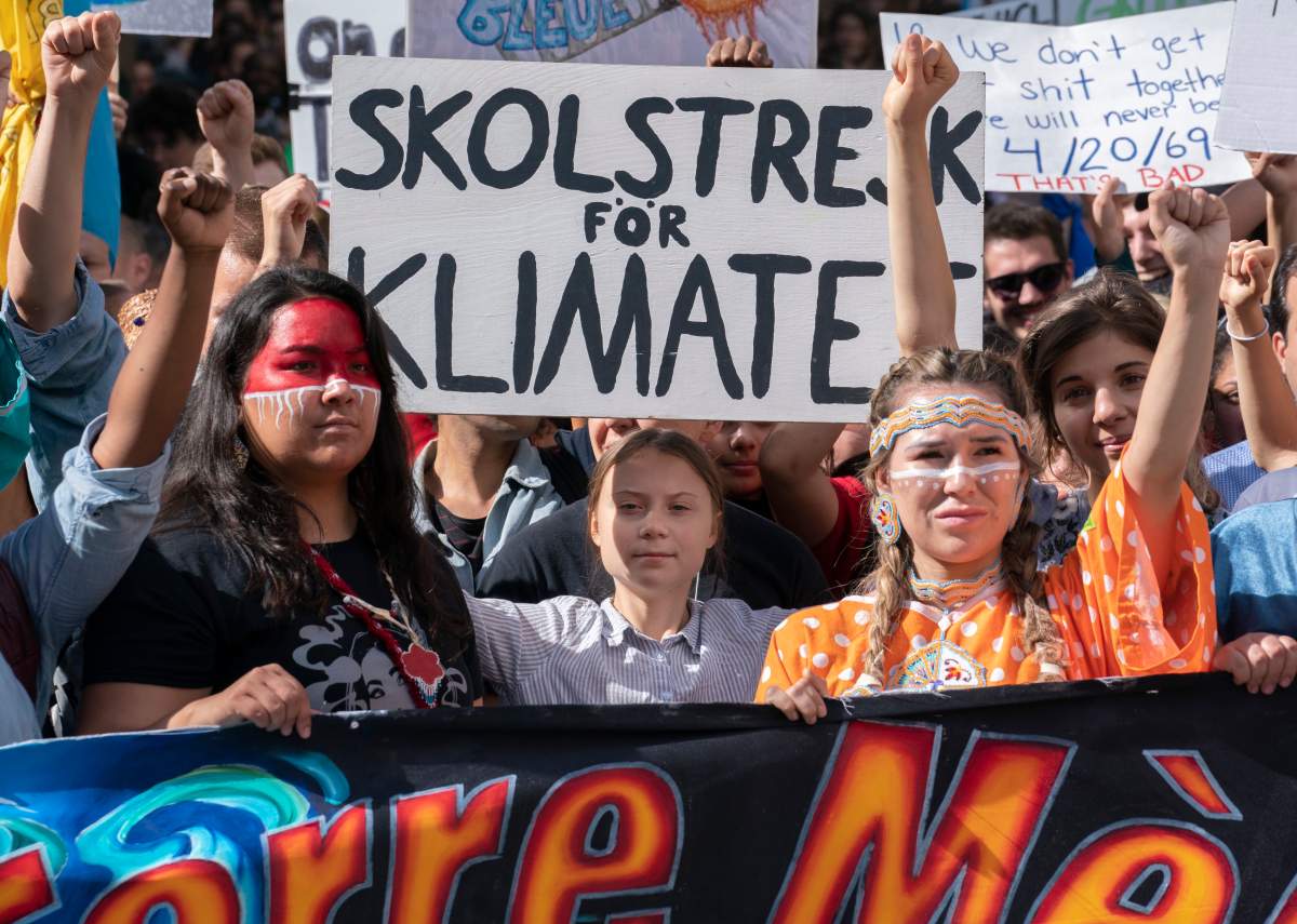 Swedish activist and student Greta Thunberg, centre, takes part in the climate strike, in Montreal on Friday, Sept. 27, 2019.