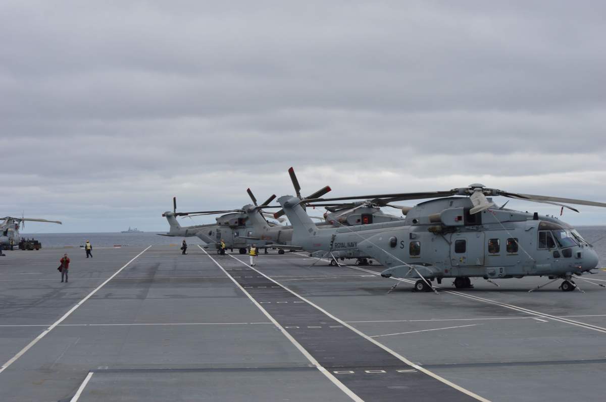 A flight of Merlin helicopters rest on the flight deck of HMS Queen Elizabeth as it arrives in Halifax Harbour on Sept. 12, 2019.