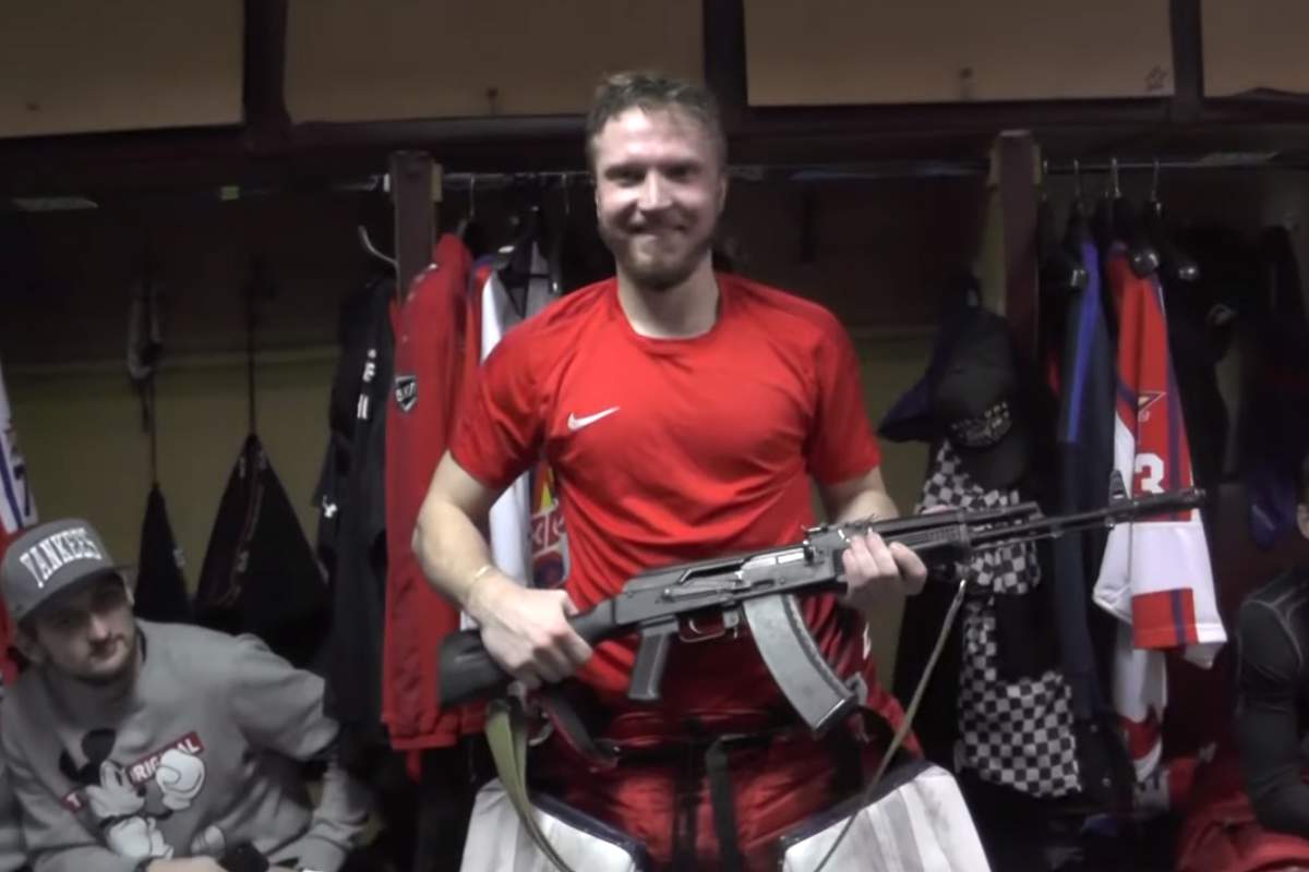 Goalie Saveli Kononov holds an AK-47 after his team, Izhstal Izhevsk, honoured his performance in a game on Sept. 10, 2019.