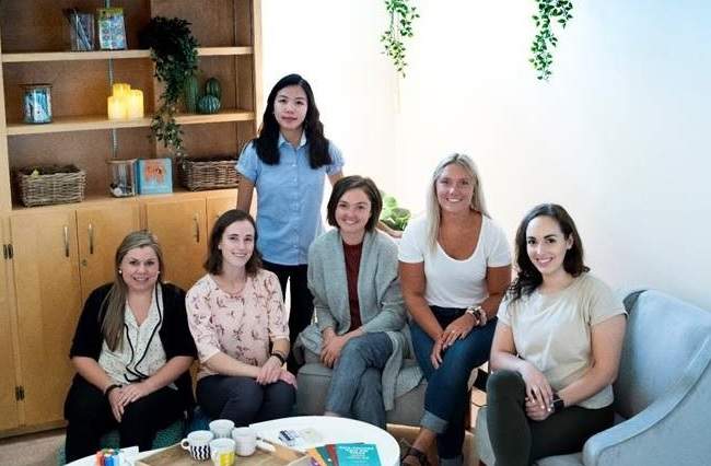 Brescia's wellness peers and their staff advisers in the university's new peer support space.