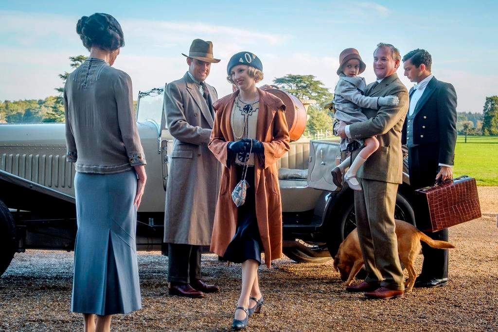 This image released by Focus Features shows Elizabeth McGovern, from left, Harry Hadden-Paton, Laura Carmichael, Hugh Bonneville and Michael Fox, right, in a scene from the film ‘Downton Abbey.’ (Jaap Buitendijk/Focus Features via AP)