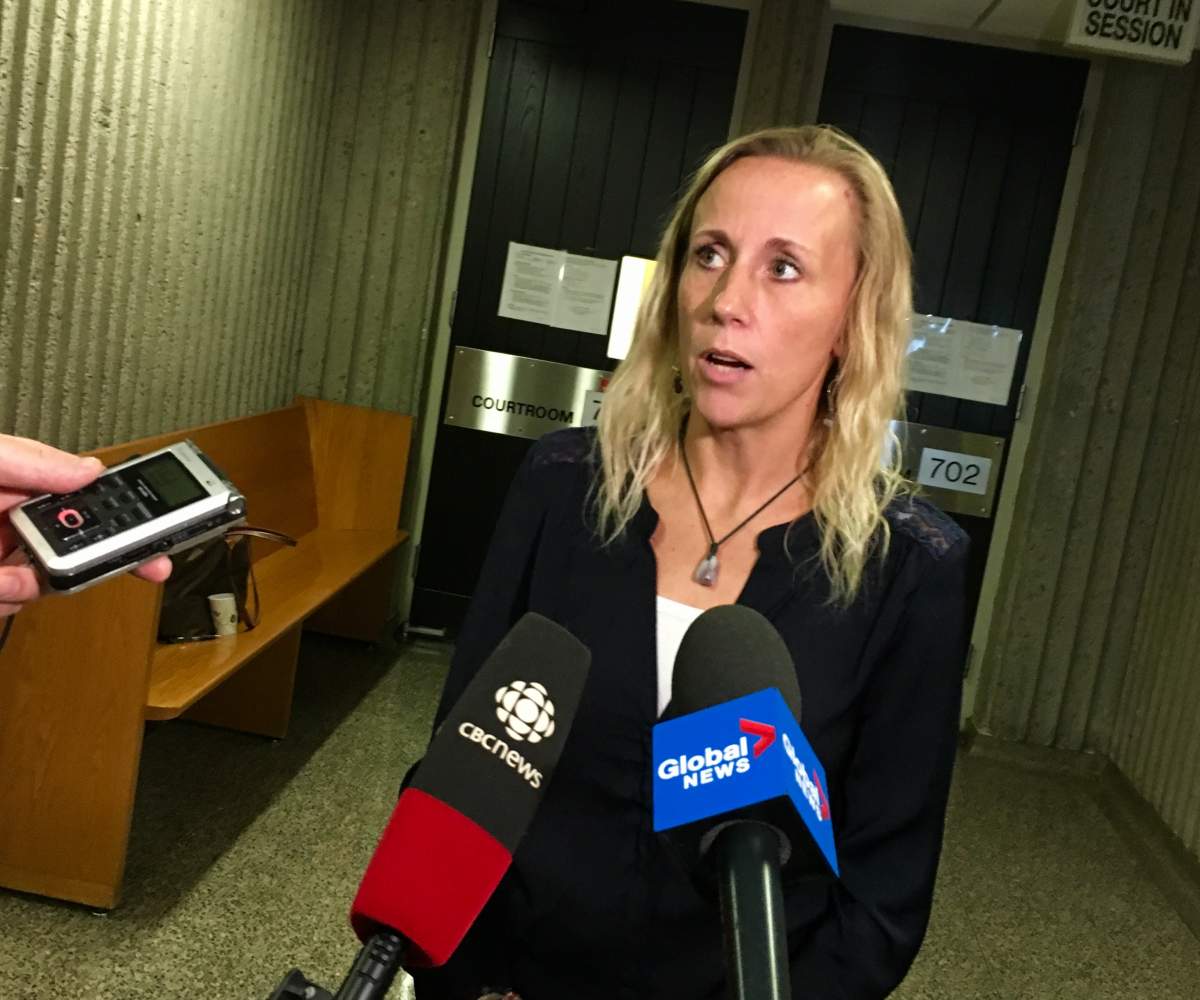 Carrie Low speaks with reporters in 2019.