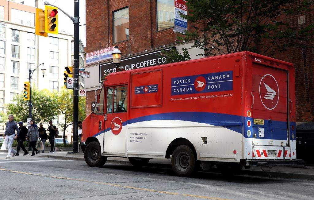 A Canada Post truck is seen illegally parked in downtown Toronto on Friday, Sept. 27, 2019. The company is closing in on $1 million a year in parking fines as it struggles with increasingly congested streets.