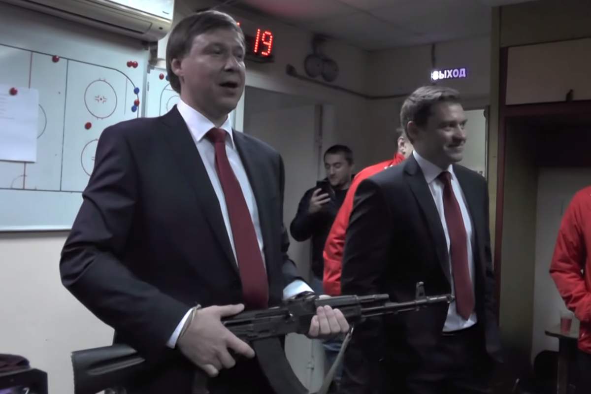 Ramil Saifullin, coach of Izhstal Izhevsk, holds an AK-47 in his team’s dressing room on Sept. 10, 2019.