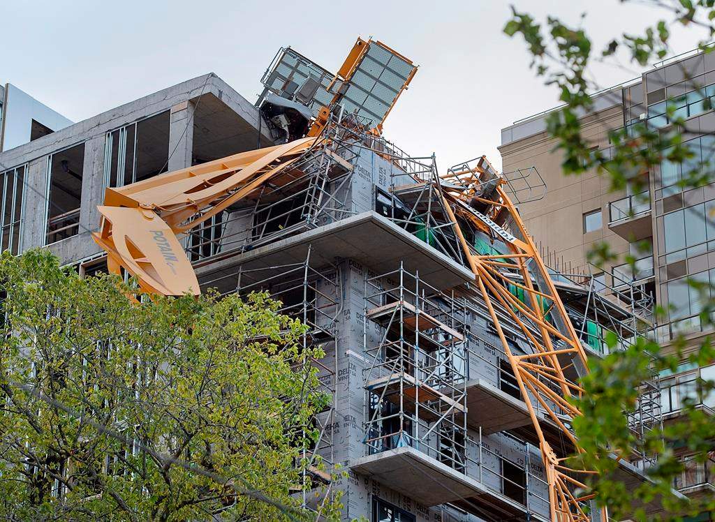A toppled building crane is draped over a new construction project in Halifax on Sunday, Sept. 8, 2019.
