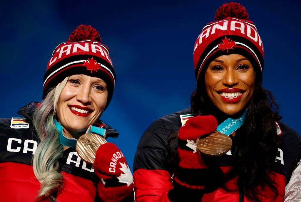 Bronze medallists in the women’s two-man bobsled Kaillie Humphries and Phylicia George, of Canada, smile during the medals ceremony at the 2018 Winter Olympics in Pyeongchang, South Korea, Thursday, Feb. 22, 2018.