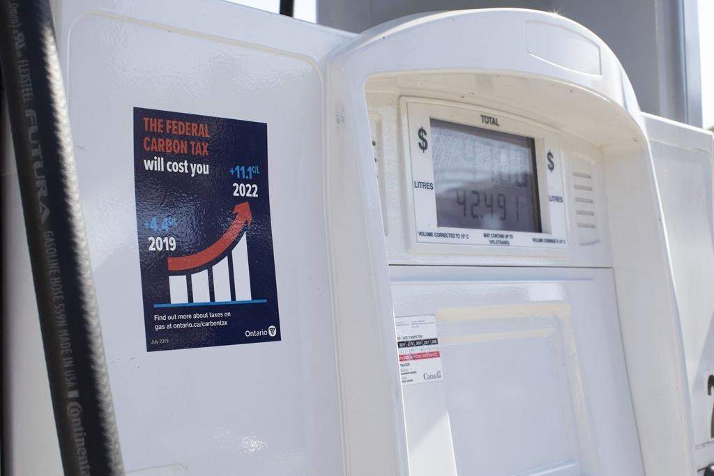 A gas pump displays an anti-carbon tax sticker in Toronto on Thursday, August 29, 2019. A civil rights group is asking the courts to declare an Ontario law mandating anti-carbon tax stickers on gas pumps to be illegal.