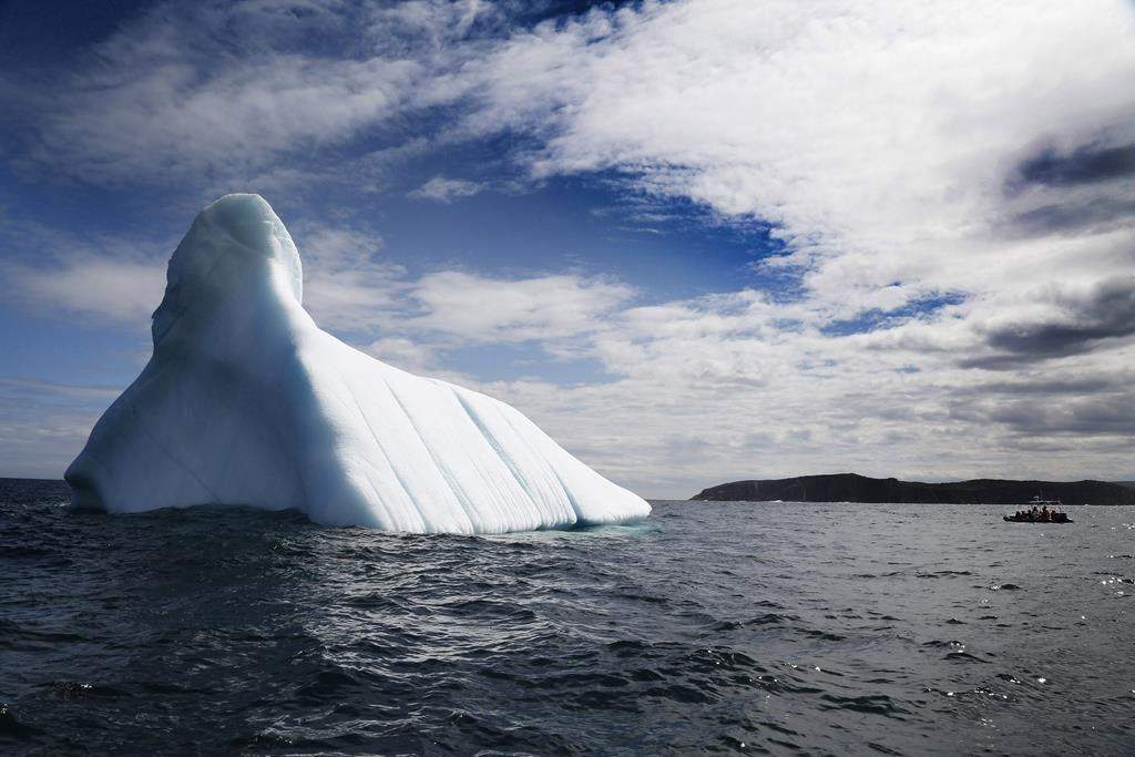Tourists up approach an iceberg in Bonavista Bay, N.L., on June 11, 2019. A report from an international scientific panel concludes that damage to Earth’s oceans and glaciers from climate change is outpacing the ability of governments to protect them. THE CANADIAN PRESS/Paul Daly