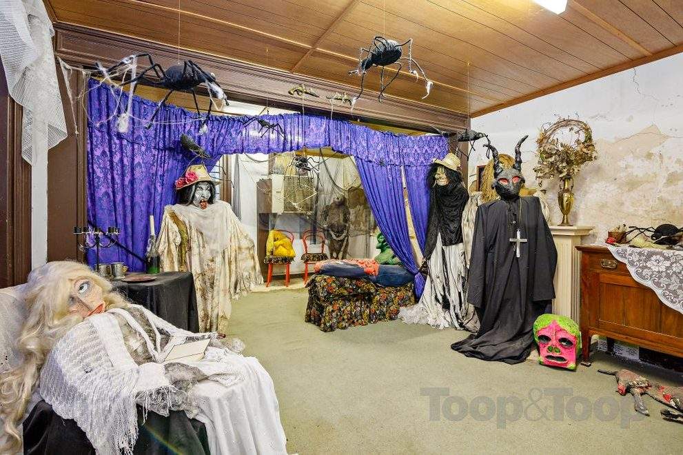 Several ghoulish figures are shown inside the Woodforde House in South Australia in this image from a real estate listing.