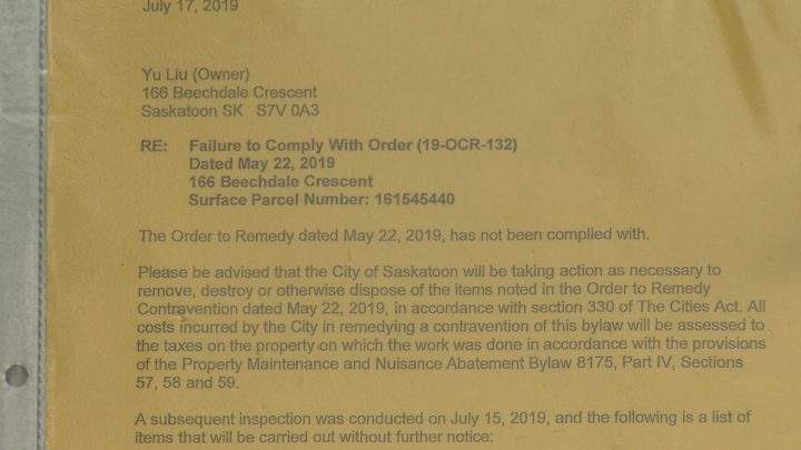A demolition notice from the City of Saskatoon is posted on the front door of the Beechdale Crescent property.