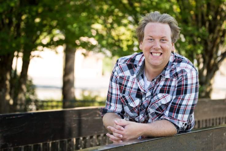 Former constituency assistant Desmond Devnich has been charged with two counts of fraud over $5000.