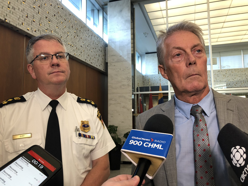 Hamilton Police Chief Eric Girt and Hamilton Mayor Fred Eisenberger speak with media following a police services board meeting.