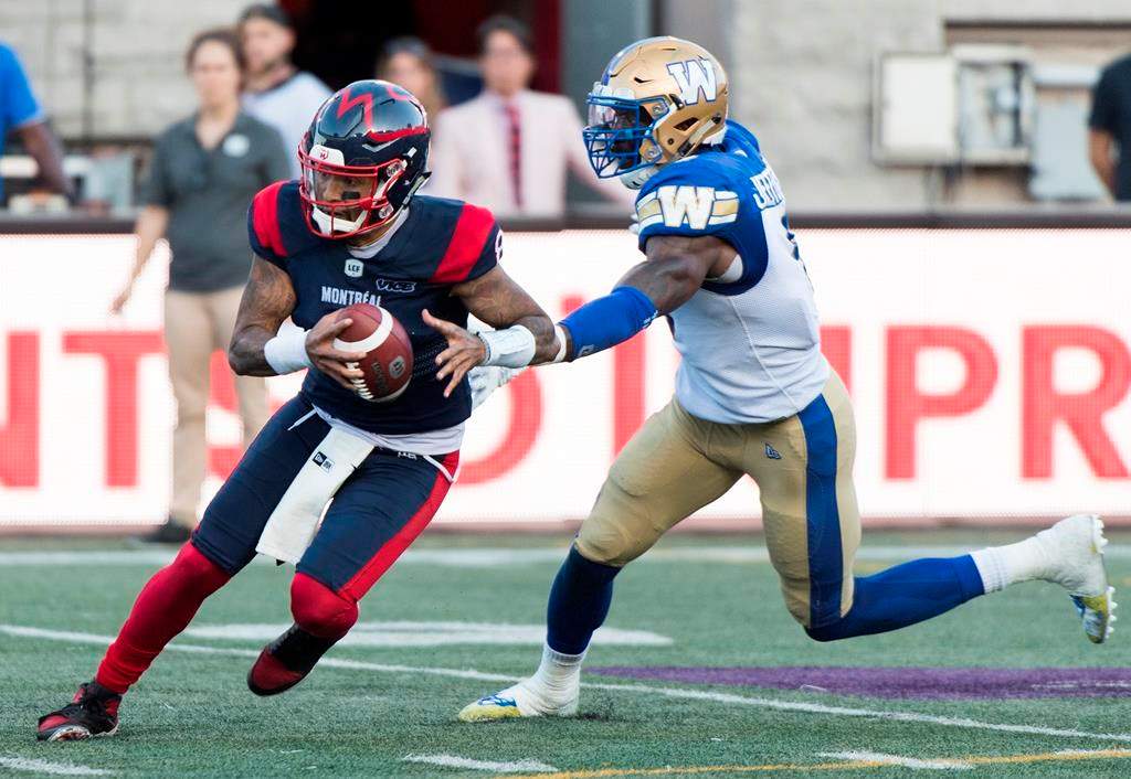 Montreal Alouettes quarterback Vernon Adams Jr., left, breaks away from Winnipeg Blue Bombers linebacker Adam Bighill during second half in Montreal, Sept. 21, 2019. The CFL is reviewing the helmet-swinging incident Saturday involving Adams Jr. and Bighill.