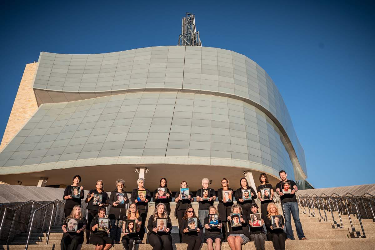 Twenty people who’ve lost someone to drug overdoses hold pictures of their loved ones at the Canadian Museum for Human Rights.