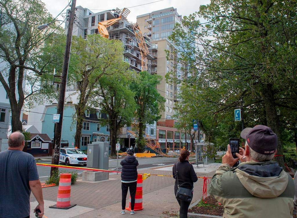 A toppled building crane is draped over a new construction project in Halifax on Sunday, Sept. 8, 2019. Hurricane Dorian brought wind, rain and heavy seas that knocked out power across the region, left damage to buildings and trees as well as disruption to transportation.