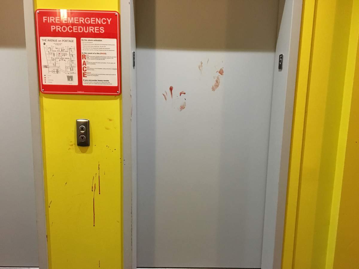 Blood spatter on the elevator doors inside the apartment.