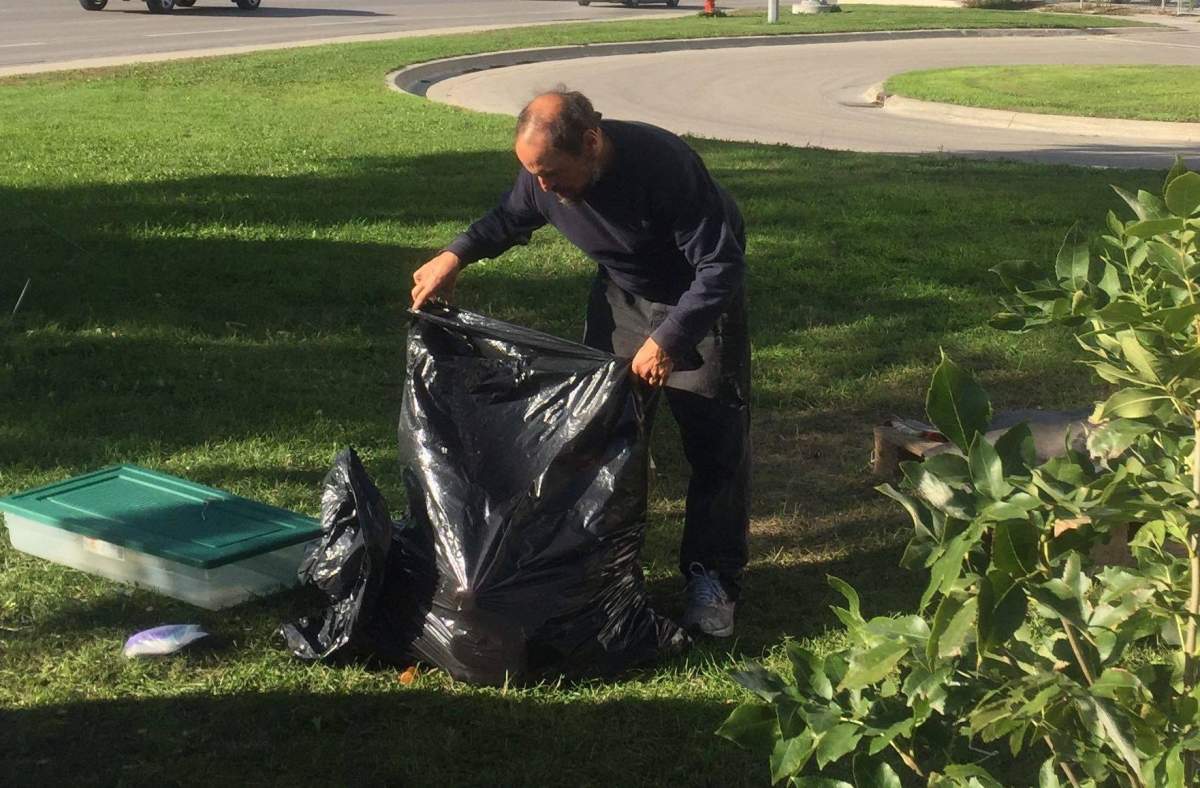 Joseph Tulloch cleans up his 'backyard' at one of Winnipeg's homeless camps.