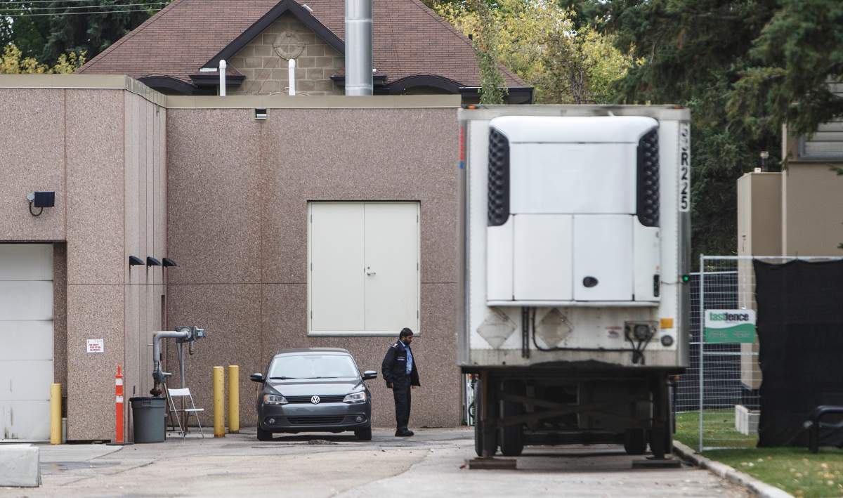 A security guard keeps an eye on a trailer where where bodies were reportedly stored in rented trailer as medical examiner copes with space shortage in Edmonton Alta, on Wednesday September 11, 2019. 